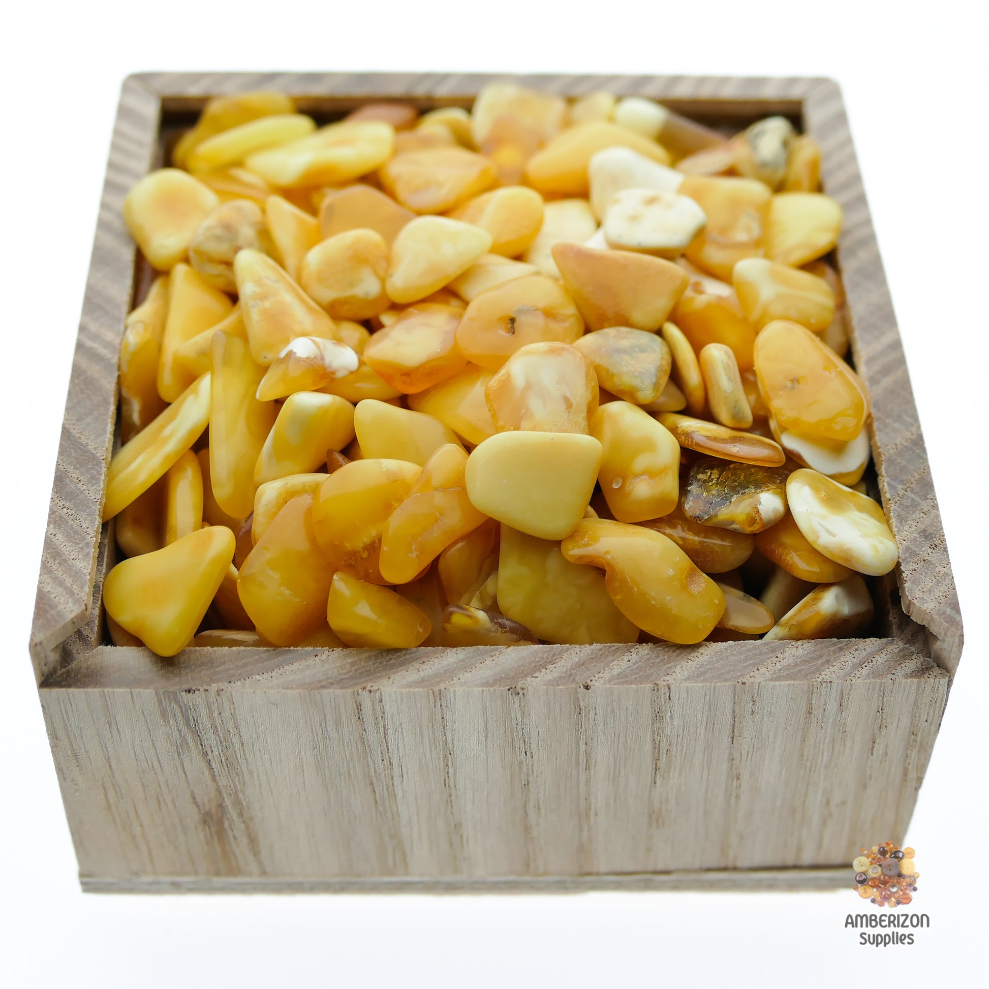 Flat butterscotch white tumbled Baltic amber chips and stones pieces for sale in bulk, high-quality natural Baltic amber