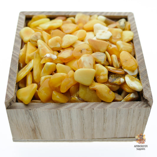 Flat butterscotch white tumbled Baltic amber chips and stones pieces for sale in bulk, high-quality natural Baltic amber